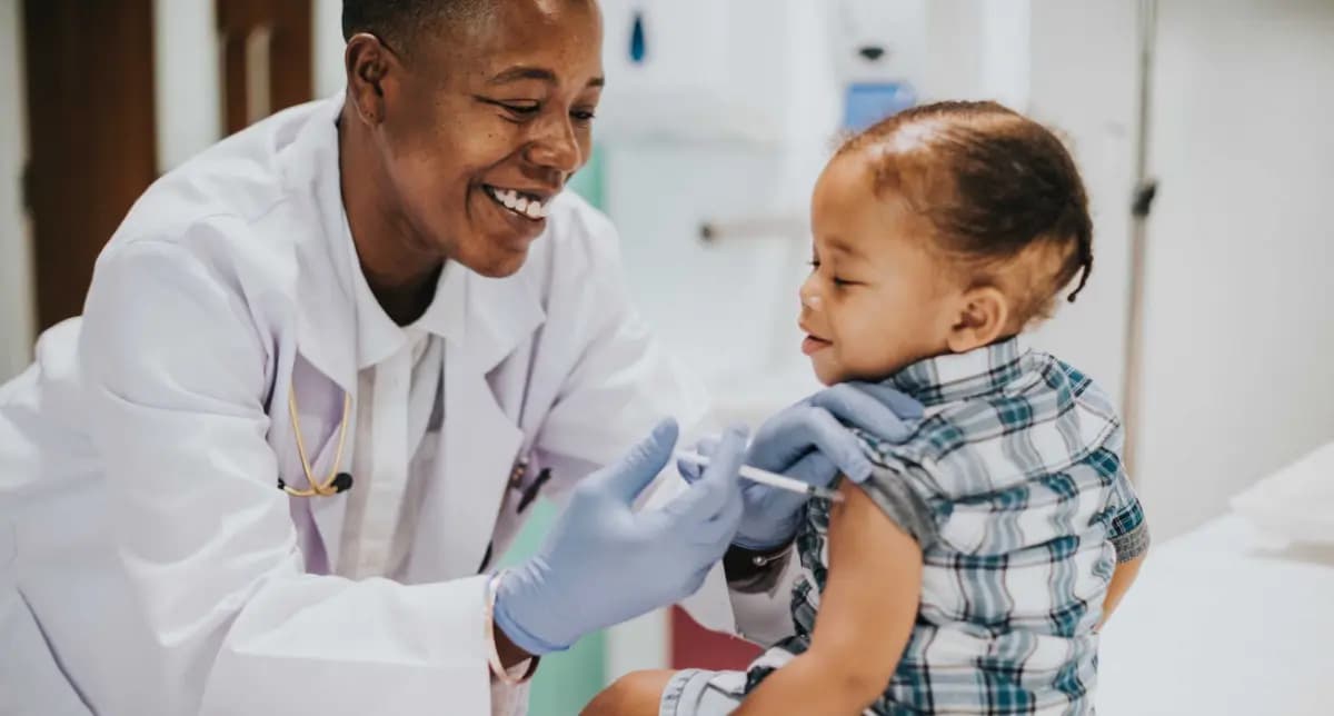 Healthcare worker immunizing a child in 2023.