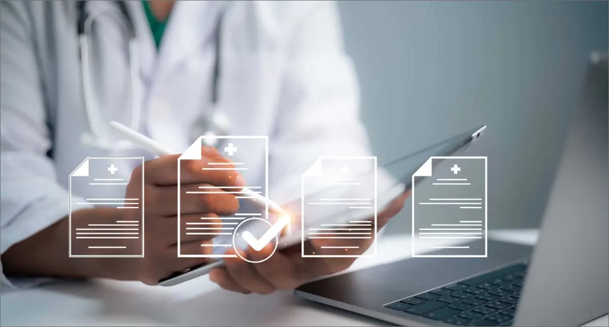 Healthcare worker using tablet with digital medical records interface in a clinical setting.